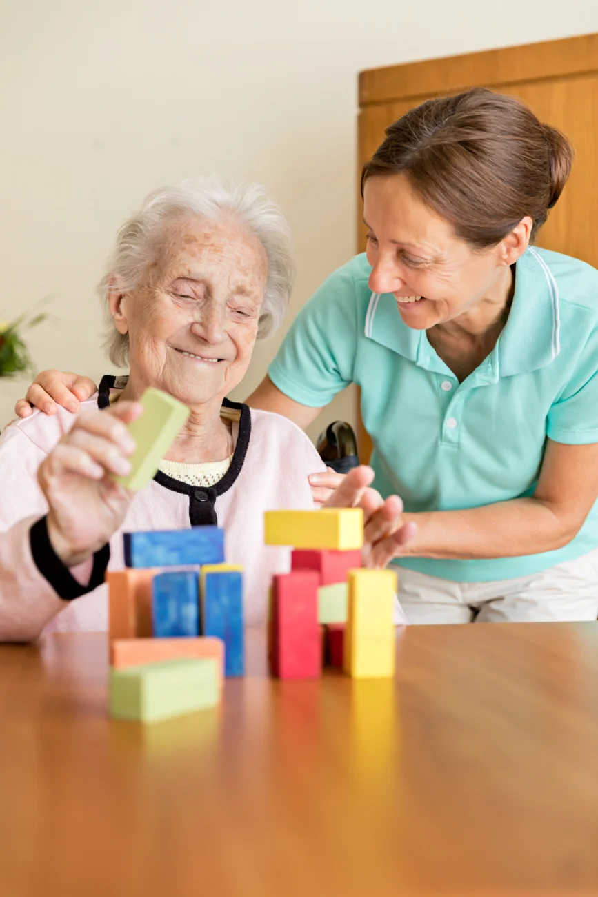 happydementiapatientwithcaregiver Dementia care resident in Georgetown residential memory care doing fun activity